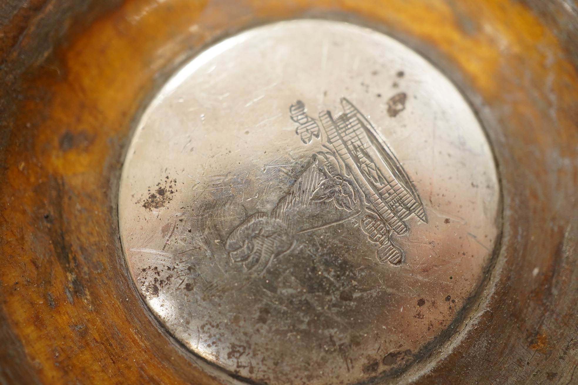 A pair of George III silver wine coasters, by Thomas & John Settle, with gadrooned borders and turned wooden bases, Sheffield, 1821, diameter 15.7cm. Condition - poor to fair